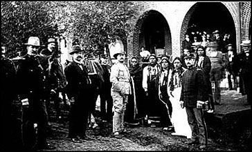 TR poses with military officials and Kiowas